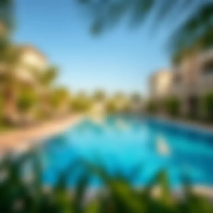 Swimming pool surrounded by lush greenery in a Dubai gated community